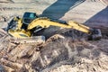 Aerial view of excavator working in quarry or construction site. Industrial top view background concept. A mining excavator is Royalty Free Stock Photo