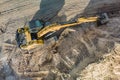 Aerial view of excavator working in quarry or construction site. Industrial top view background concept. A mining excavator is Royalty Free Stock Photo