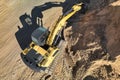 Aerial view of excavator working in quarry or construction site. Industrial top view background concept. A mining excavator is Royalty Free Stock Photo