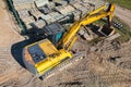 Aerial view of excavator working in quarry or construction site. Industrial top view background concept. A mining excavator is Royalty Free Stock Photo