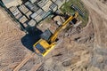 Aerial view of excavator working in quarry or construction site. Industrial top view background concept. A mining excavator is Royalty Free Stock Photo