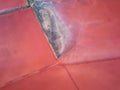 Aerial view of extremely salty lake with wooden logs for salt extraction in the pink water, natural abstract background