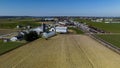 Aerial View Of A Farm Complex With Multiple Barns, Silos, And Plowed Fields In A Rural Setting Royalty Free Stock Photo