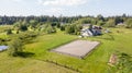 Drone view of farm house and green pastures