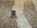 Farm tractor harrowing arable field