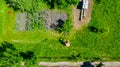 Aerial view of farmer mowing a lawn in his garden with a petrol lawn mower Royalty Free Stock Photo