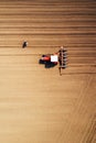 Aerial view of farmer and tractor with crop seeder