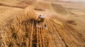 Aerial view of farmer using combine harvester and working the fields Royalty Free Stock Photo