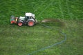 Aerial View of Farmer Watering Grass Fields with Agricultural Machinery