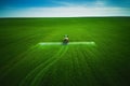 Aerial view of farming tractor plowing and spraying on field Royalty Free Stock Photo