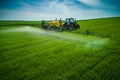 Aerial view of farming tractor plowing and spraying on field Royalty Free Stock Photo