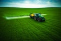 Aerial view of farming tractor plowing and spraying on field Royalty Free Stock Photo