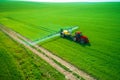 Aerial view of farming tractor plowing and spraying on field Royalty Free Stock Photo