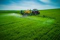 Aerial view of farming tractor plowing and spraying on field Royalty Free Stock Photo