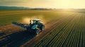 Aerial view of farming tractor plowing and spraying on field