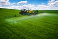 Aerial view of farming tractor plowing and spraying on field Royalty Free Stock Photo