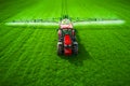 Aerial view of farming tractor plowing and spraying on field Royalty Free Stock Photo