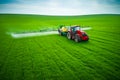 Aerial view of farming tractor plowing and spraying on field Royalty Free Stock Photo