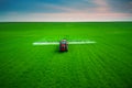 Aerial view of farming tractor plowing and spraying on field Royalty Free Stock Photo