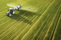 Aerial view of farming tractor spraying on field