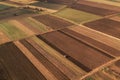 Aerial view of farmland field tillage with tractor
