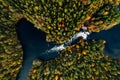 Aerial view of fast river in beautiful orange and red autumn forest, Finland Royalty Free Stock Photo