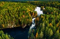 Aerial view of fast river in beautiful orange and red autumn forest, Finland Royalty Free Stock Photo