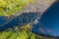 Aerial view of a fast river in nature surrounded by trees Royalty Free Stock Photo