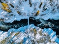 Aerial view of fast river with suspension foot bridge. Snow winter forest in Finland Royalty Free Stock Photo