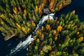 Aerial view of fast and wooden cabin in beautiful orange and red autumn forest. Oulanka National Park, Finland Royalty Free Stock Photo