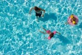 Aerial view of a father and his two kids in the pool, playing Royalty Free Stock Photo