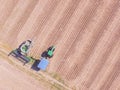 Aerial view field after crop with harvester machines