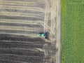 Aerial view on the tractor working on the large sunflowers field sunny day Royalty Free Stock Photo