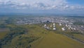 Aerial view of field with trees near the industrial area located outside the city. Clip. Amazing view of factories tanks Royalty Free Stock Photo