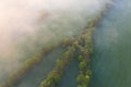 Aerial view of fields and lines of green trees, during sunrise. Beautiful universal countryside with green fields and meadows. Royalty Free Stock Photo