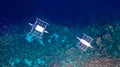 Aerial view of Filipino boats floating on top of clear blue waters, Moalboal is a deep clean blue ocean and has many local Royalty Free Stock Photo