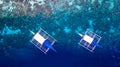 Aerial view of Filipino boats floating on top of clear blue waters, Moalboal is a deep clean blue ocean and has many local Royalty Free Stock Photo