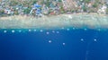 Aerial view of Filipino boats floating on top of clear blue waters, Moalboal is a deep clean blue ocean and has many local Royalty Free Stock Photo