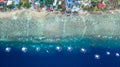Aerial view of Filipino boats floating on top of clear blue waters, Moalboal is a deep clean blue ocean and has many local