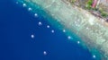 Aerial view of Filipino boats floating on top of clear blue waters, Moalboal is a deep clean blue ocean and has many local Royalty Free Stock Photo