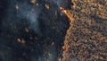 Aerial view Fire extinguishing. Fireman extinguishing burning dry grass.