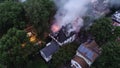 Aerial view of fire trucks and apparatus battling a house fire