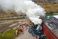 Aerial view of firemen fighting with fire near old factory biulding in industrial area Royalty Free Stock Photo