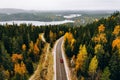 Aerial view of first snowy autumn color forest in the mountains and a road with car in Finland Lapland Royalty Free Stock Photo