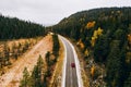 Aerial view of first snowy autumn color forest in the mountains and a road with car in Finland Lapland Royalty Free Stock Photo