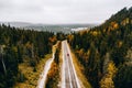 Aerial view of first snowy autumn color forest in the mountains and a road with car in Finland Lapland Royalty Free Stock Photo