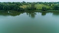 Drone aerial view fisherman is fishing sitting on an inflatable boat in lake Royalty Free Stock Photo