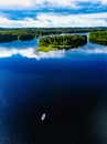 Aerial view of fishing boat in blue lake landscape with green forests on a sunny summer day in Finland Royalty Free Stock Photo