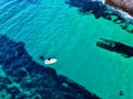 Aerial view of a fishing boat sailing in a tranquil sea on a sunny day Royalty Free Stock Photo