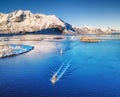 Aerial view of fishing boats, bridge, mountains and ocean. Boats on the Lofoten islands, Norway.